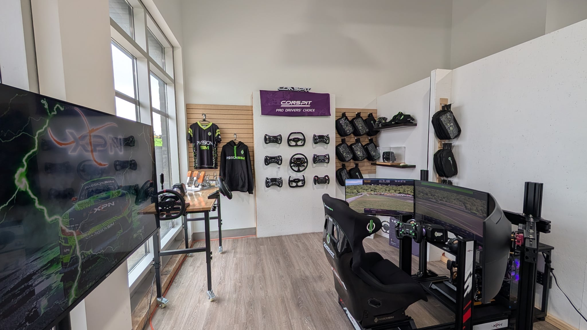 Le showroom PassionSim à Québec : mur de volants Conspit et simulateur de course monté
